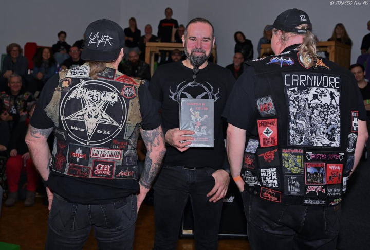 Kumpels in Kutten: Der Autor zwischen zwei Heavy-Metal-Fans mit Kutten, die mit dem Rücken zur Kamera stehen. Dadurch sieht man die Kutten, die dem Buch den Namen geben.